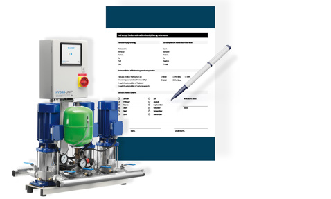 Hydro-enhed pumpesystem med kontrolpanel, ved siden af en formular og pen.