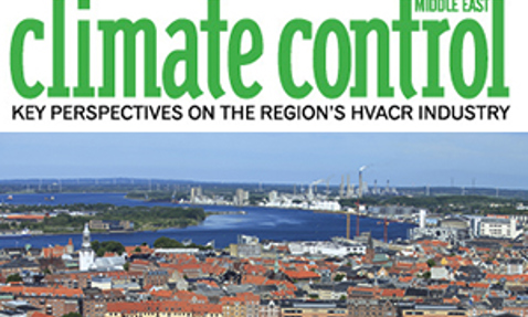 Aerial view of a coastal city under "Climate Control Middle East" magazine title.