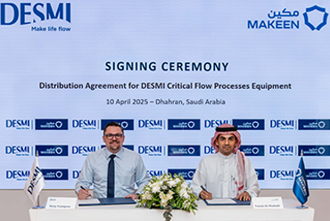 Two men signing DESMI distribution agreement in Dhahran, Saudi Arabia.