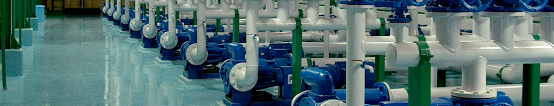Industrial pump system with blue and white pipes for fluid handling.