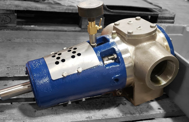 Blue DESMI pump on wooden pallet for fluid handling applications.