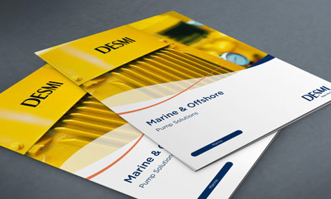 桌子上的DESMI Marine & Offshore泵解决方案手册。