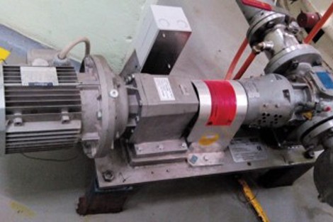 Industrial pump system with motor and pipes, used for fluid handling.