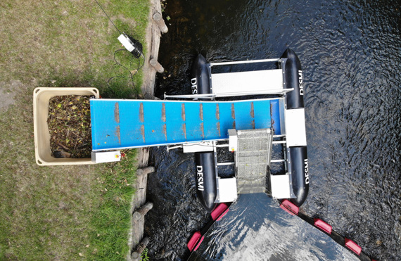 DESMI trash collection system on water, conveyor belt transporting waste to container.