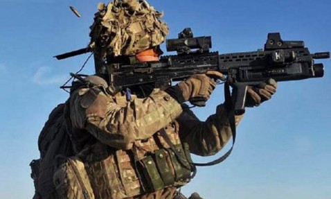 Magazine cover featuring a soldier with a rifle and military vehicles below.