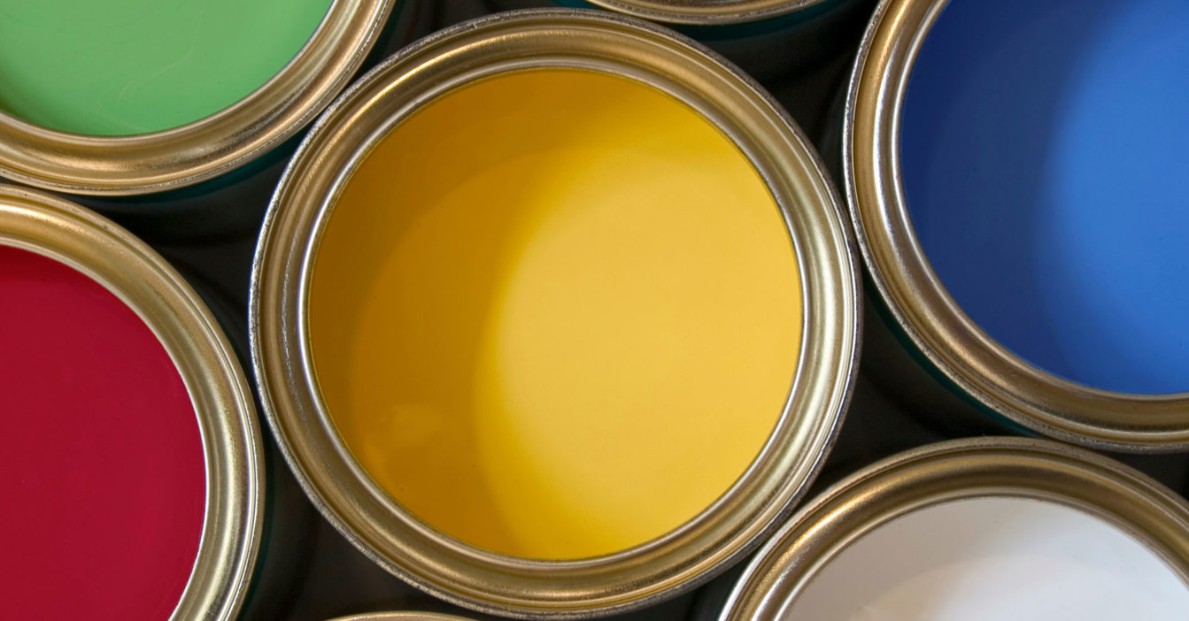 Open paint cans displaying various vibrant colors, including green, yellow, and blue.