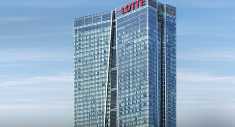 Tall glass skyscraper with "LOTTE" signage against a clear blue sky.