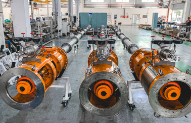 Industrial facility with large orange DESMI pumps for fluid handling applications.