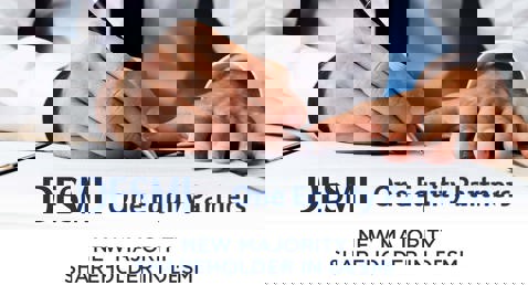 Hands signing a document, announcing One Equity Partners as DESMI's new majority shareholder.