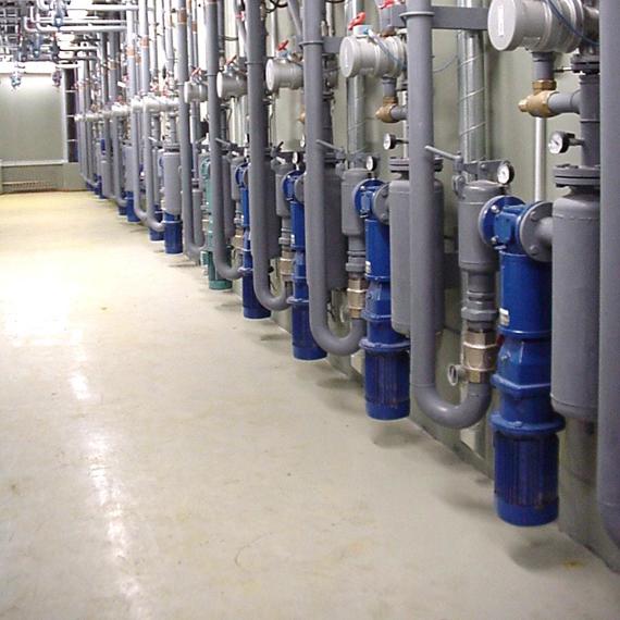 Industrial piping system with multiple pumps and valves in a facility.