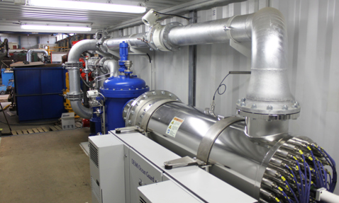 Industrial setup with DESMI Ocean Guard equipment and interconnected pipes for fluid handling.