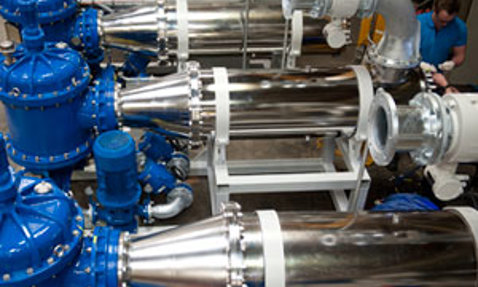 Industrial pumps with blue and silver components for fluid handling applications.