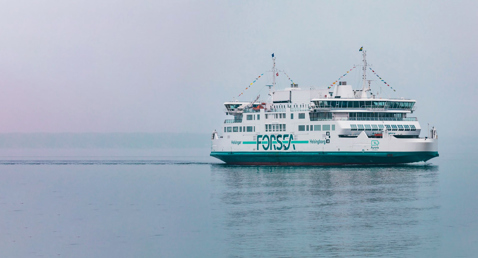 Ferry named Aurora sails calmly in foggy waters, displaying "FORSEA" branding.