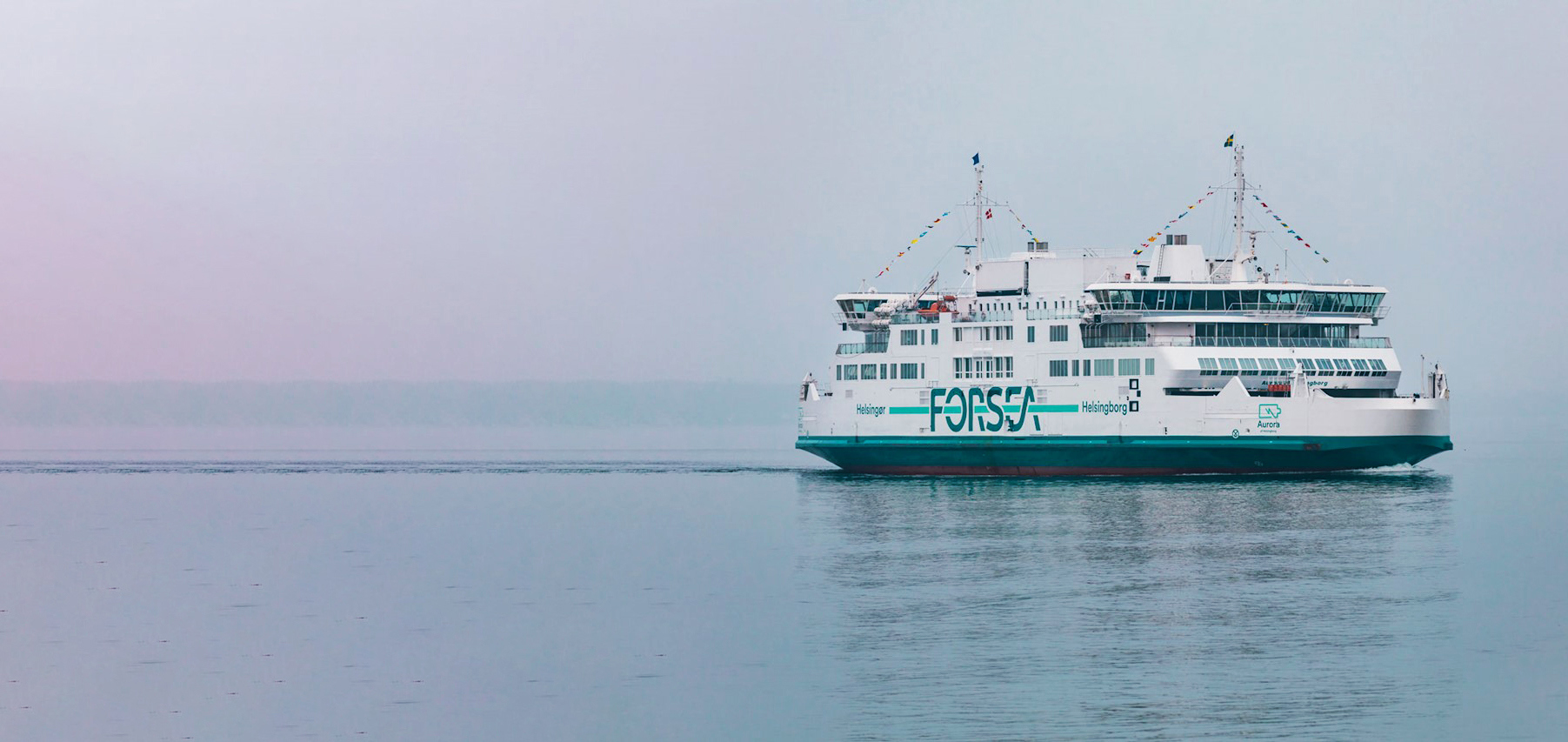 Ferry named Aurora sails calmly in foggy waters, displaying "FORSEA" branding.