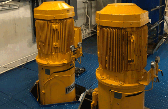 Yellow DESMI vertical centrifugal pumps in an industrial fluid handling setting.