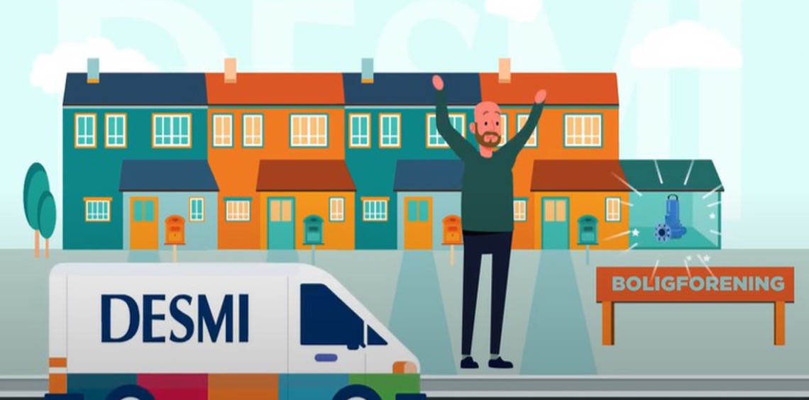 DESMI van in front of colorful houses, man cheering, sign reads "BOLIGFORENING".