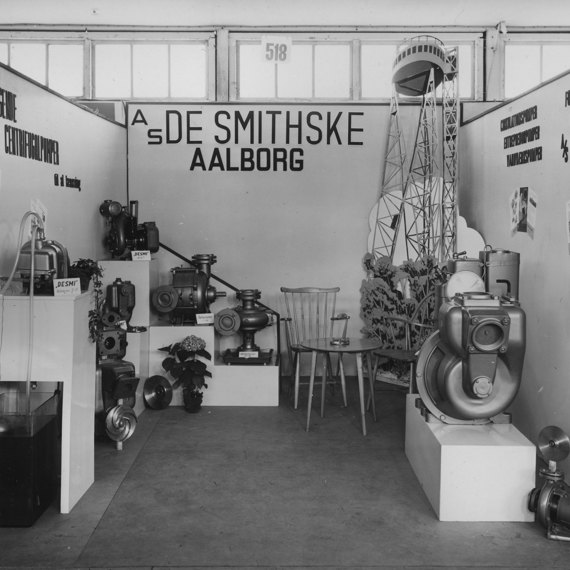 DESMI trade show booth displaying various centrifugal pumps and industrial equipment.