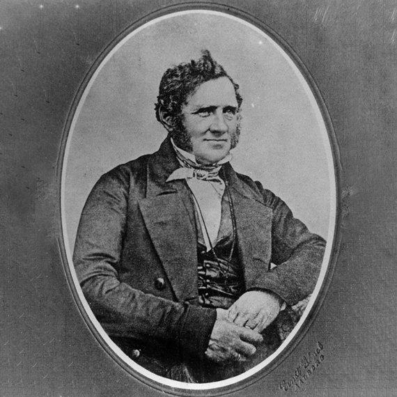 Black and white portrait of a man in 19th-century formal attire.