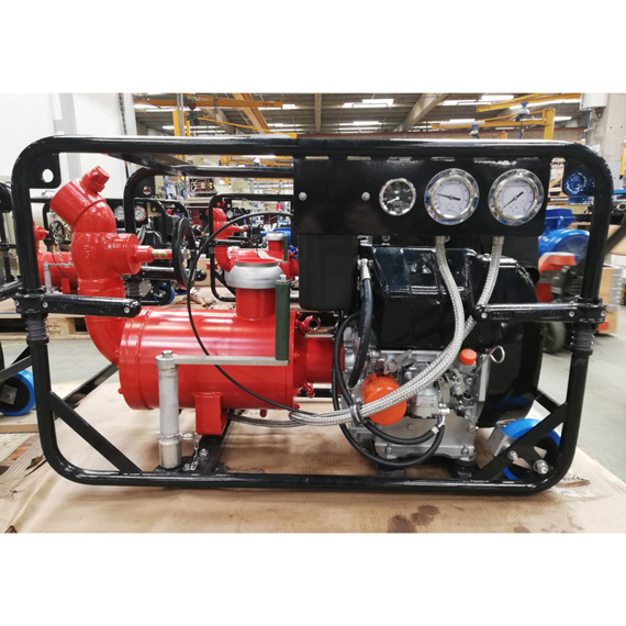 Red industrial pump with gauges, mounted on a black metal frame in a workshop.