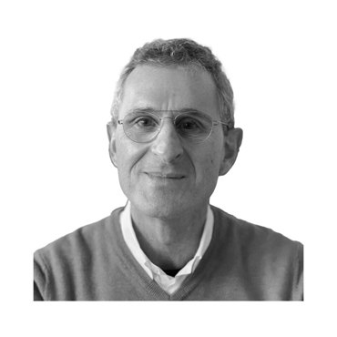 Black and white portrait of a man wearing glasses and a sweater.