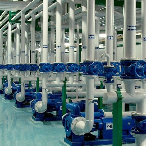 Industrial setup with multiple blue and white DESMI pumps for fluid handling.