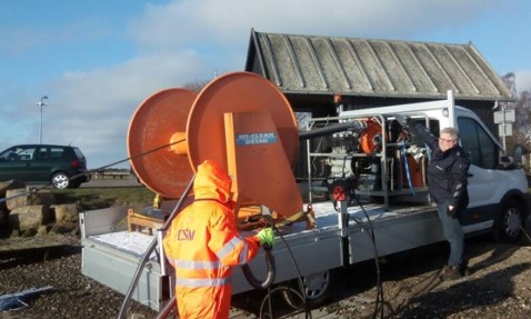 Person operating DESMI equipment on a trailer for fluid handling.