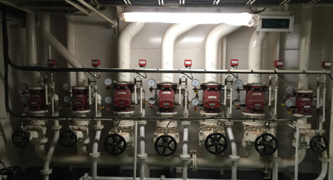 Industrial piping system with multiple valves and gauges for fluid handling.