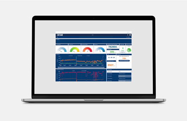 Two men standing beside a yellow DESMI pump in an industrial setting.