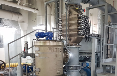 Industrial fluid handling system with pipes, valves, and a DESMI filtration unit.