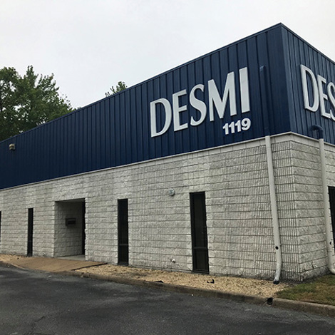 DESMI building exterior with blue and gray facade, labeled "DESMI 1119".