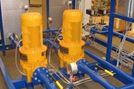 Two yellow DESMI pumps in a blue industrial fluid handling system.
