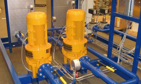 Two yellow DESMI pumps in a blue industrial fluid handling system.