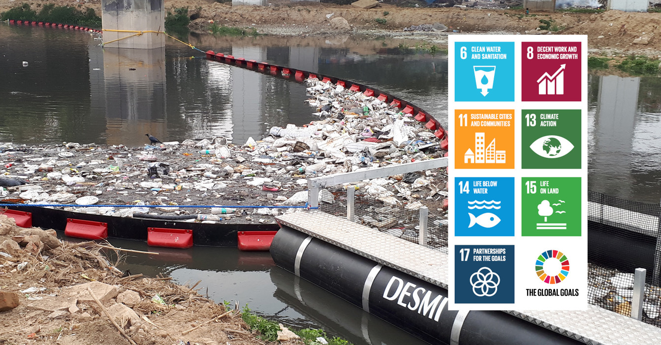 DESMI barrier collecting river debris, promoting sustainable development goals for clean water.