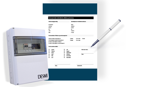 DESMI control panel next to a form and pen for fluid handling documentation.