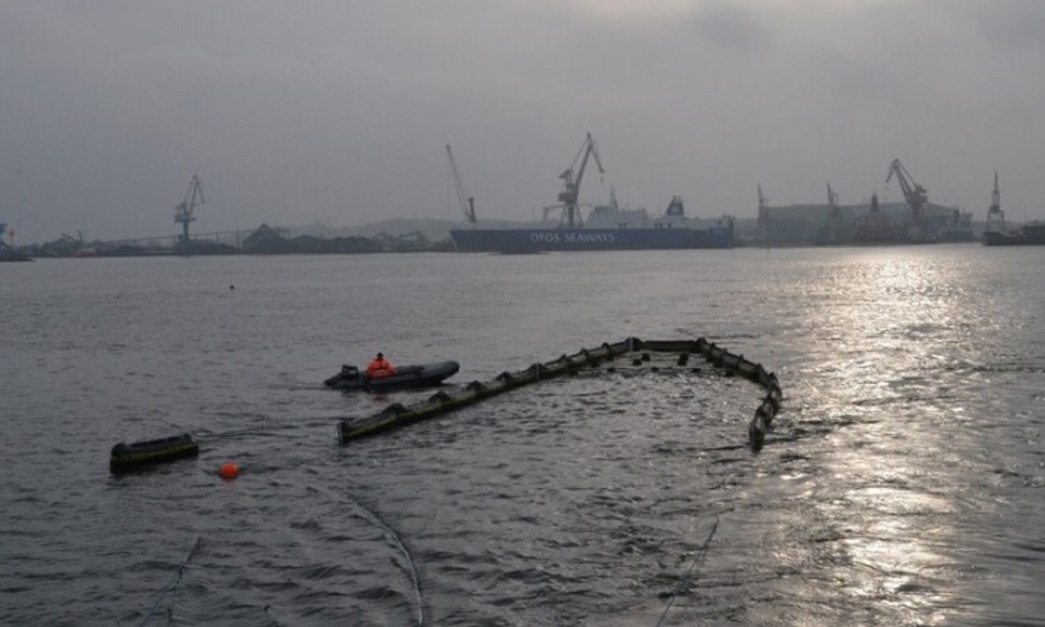 DESMI oil recovery boom deployed on water with a response craft