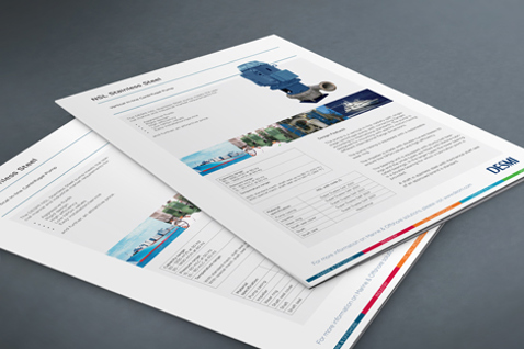 DESMI brochure pages featuring industrial pump specifications on a gray surface.