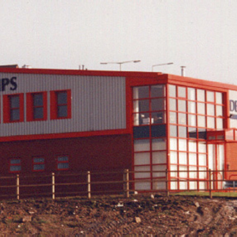 Industrial building labeled "DESMI PUMPS" with red and white exterior.