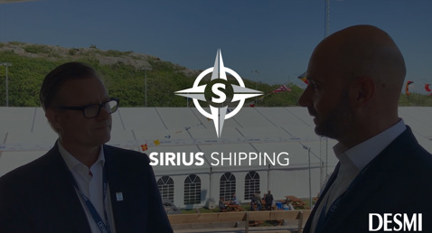 Two men conversing outdoors with Sirius Shipping and DESMI logos visible.