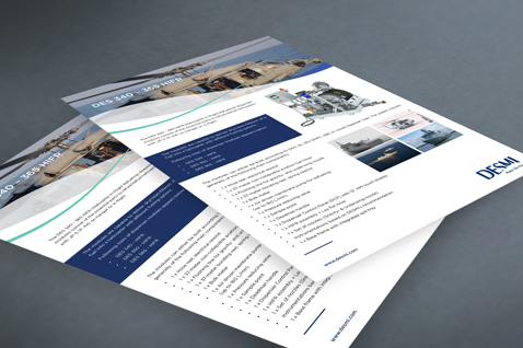 Two DESMI product brochures with images and text, lying on a surface.