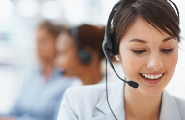 Smiling customer service representative wearing a headset, assisting clients.