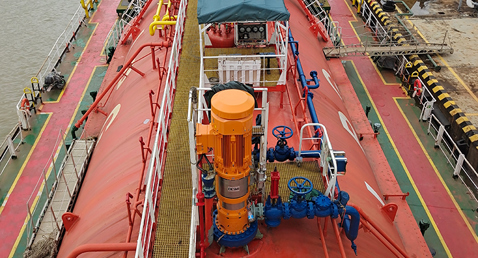 Ship deck with a DESMI vertical pump installed for fluid handling operations.