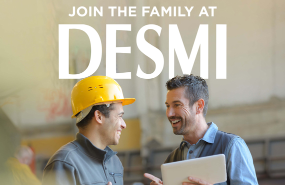 Two workers smiling, one with a hard hat, promoting DESMI recruitment.