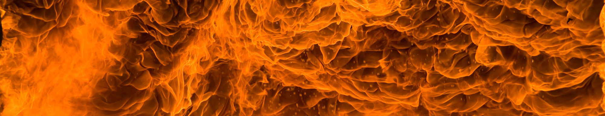 Close-up of intense orange flames with swirling patterns.