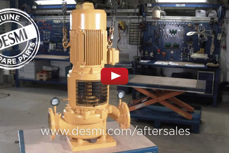 DESMI pump in a workshop with tools and "Genuine DESMI Spare Parts" label.