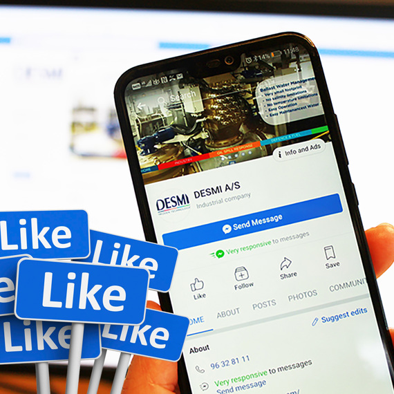 Smartphone displaying DESMI A/S Facebook page with multiple "Like" icons in foreground.