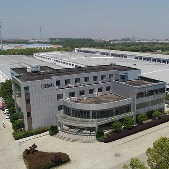 Aerial view of DESMI industrial facility surrounded by trees and wide pathways.