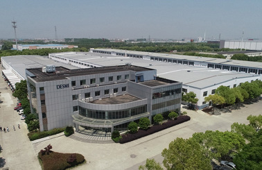 Aerial view of DESMI industrial facility surrounded by trees and wide pathways.