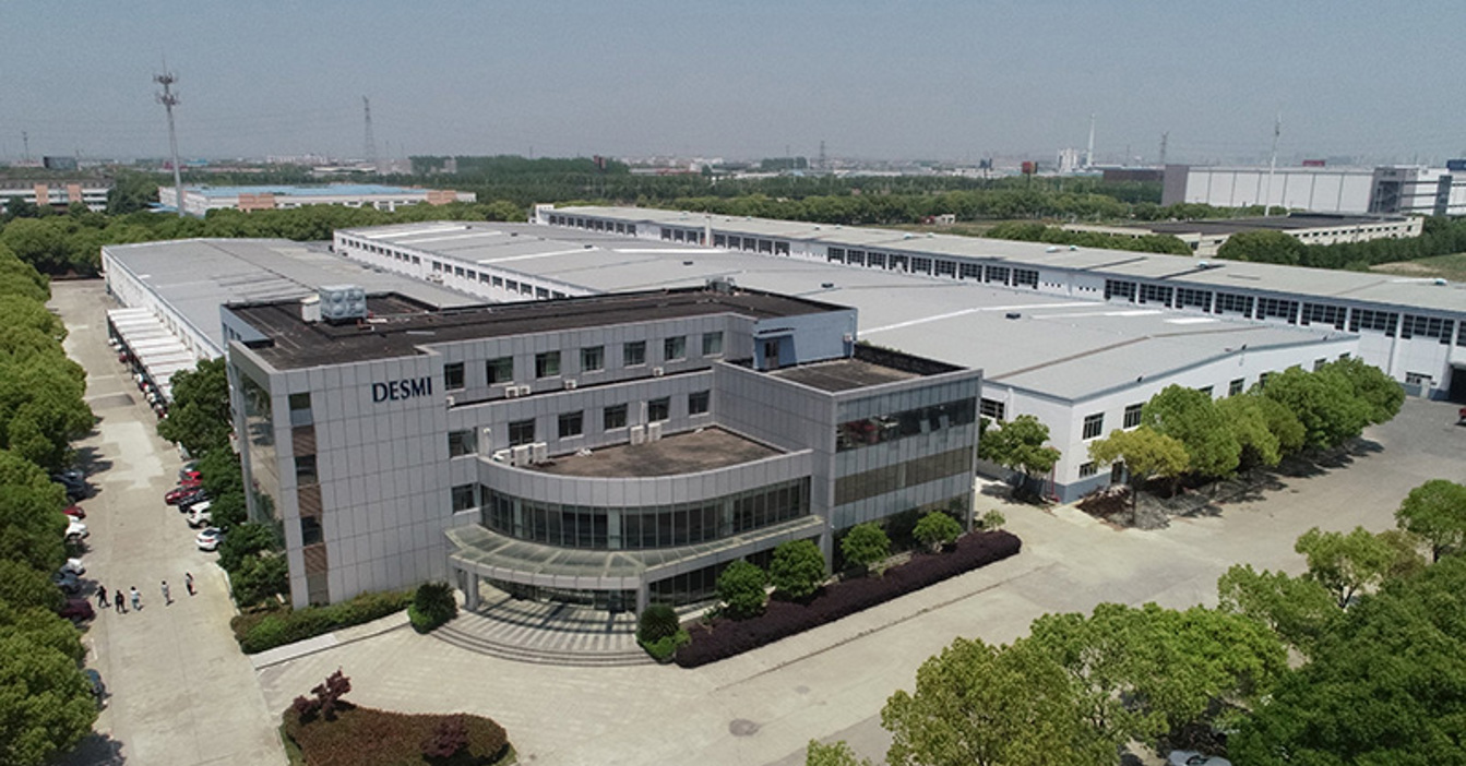 Aerial view of DESMI industrial facility surrounded by trees and wide pathways.