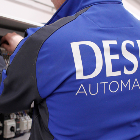 DESMI technician working on electrical panel for automation setup.