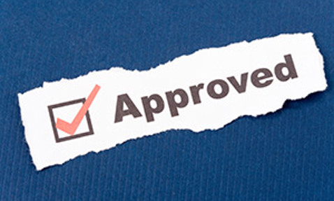 Torn paper with "Approved" and a red checkmark on a blue background.